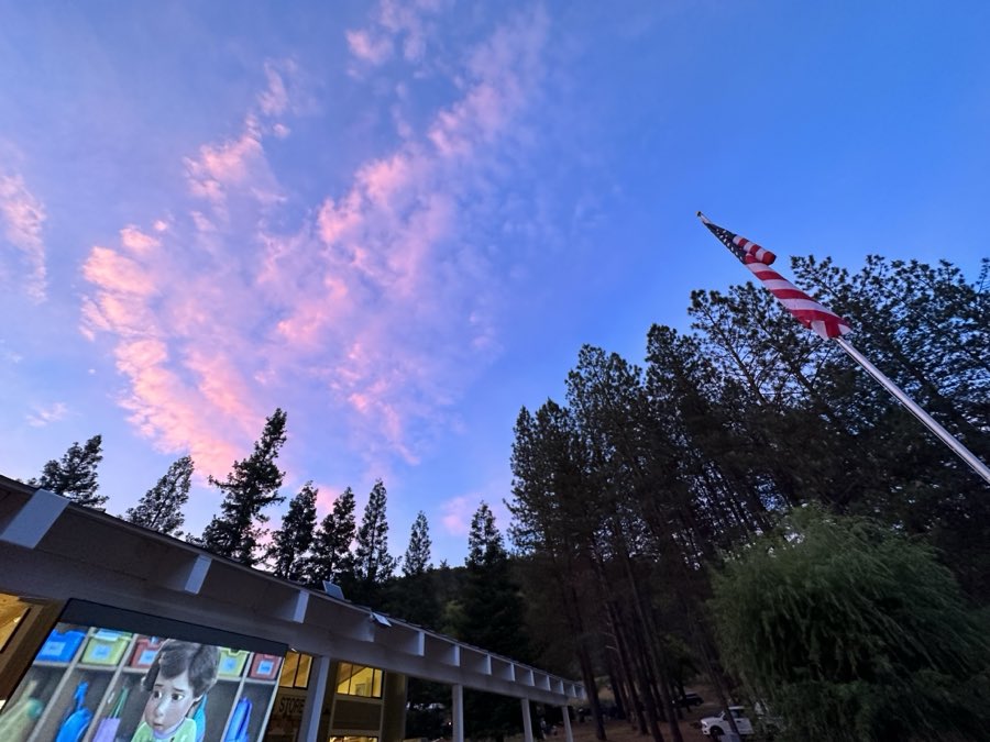 Pink sunset clouds above the General Store with the movie screen set up