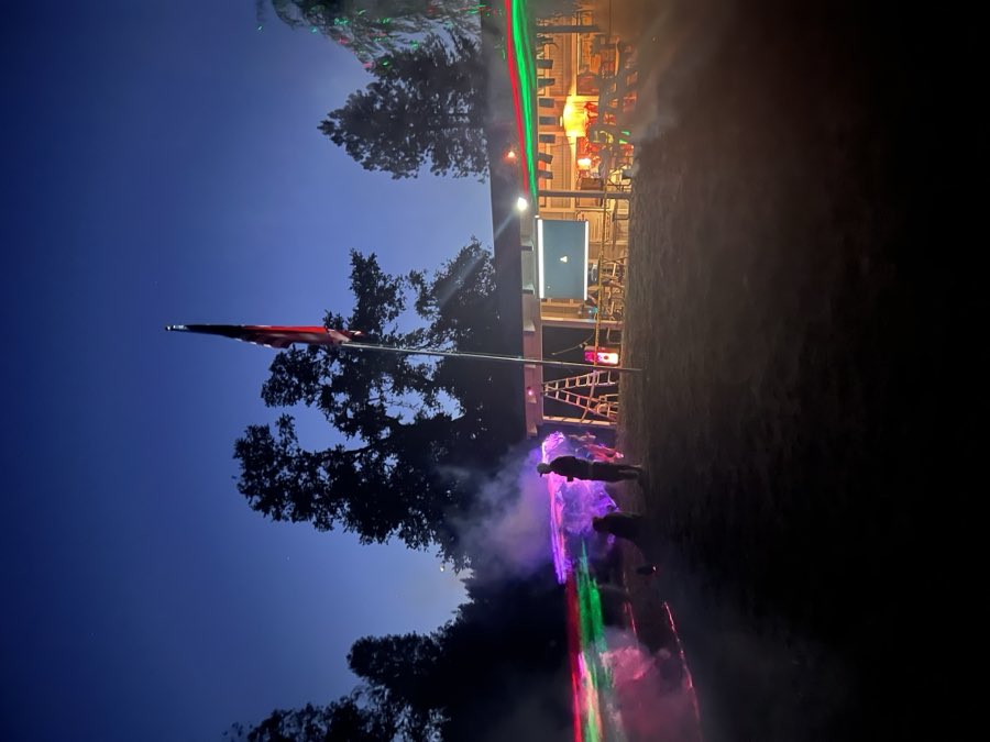 Laser lights and fog around the flagpole during a night event at the lodge